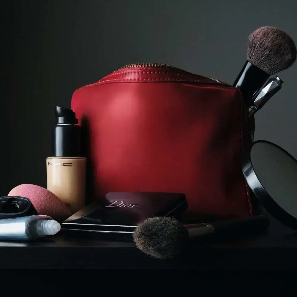 Red makeup bag with a variety of products