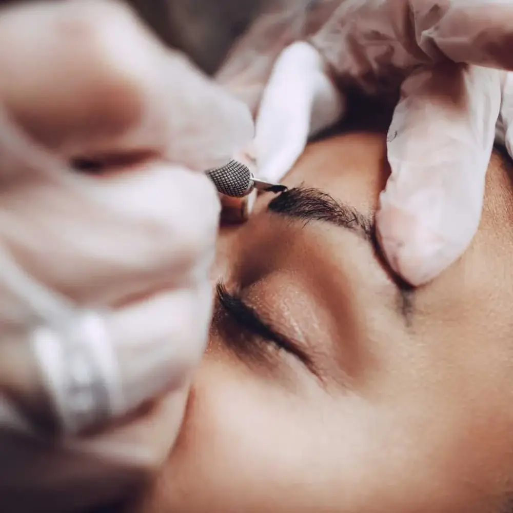 Professional artist performing best microblading eyebrows procedure