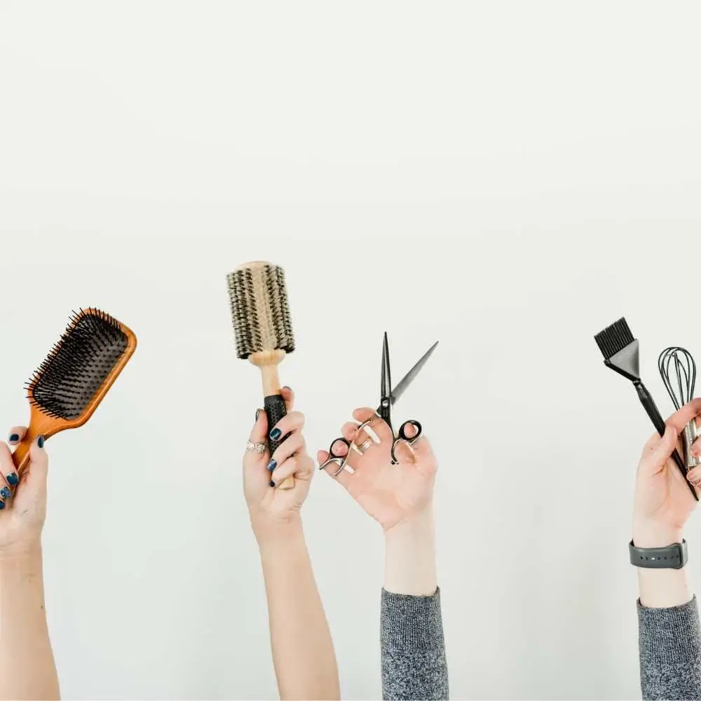 Hand holding the most recommended brush for hair extensions