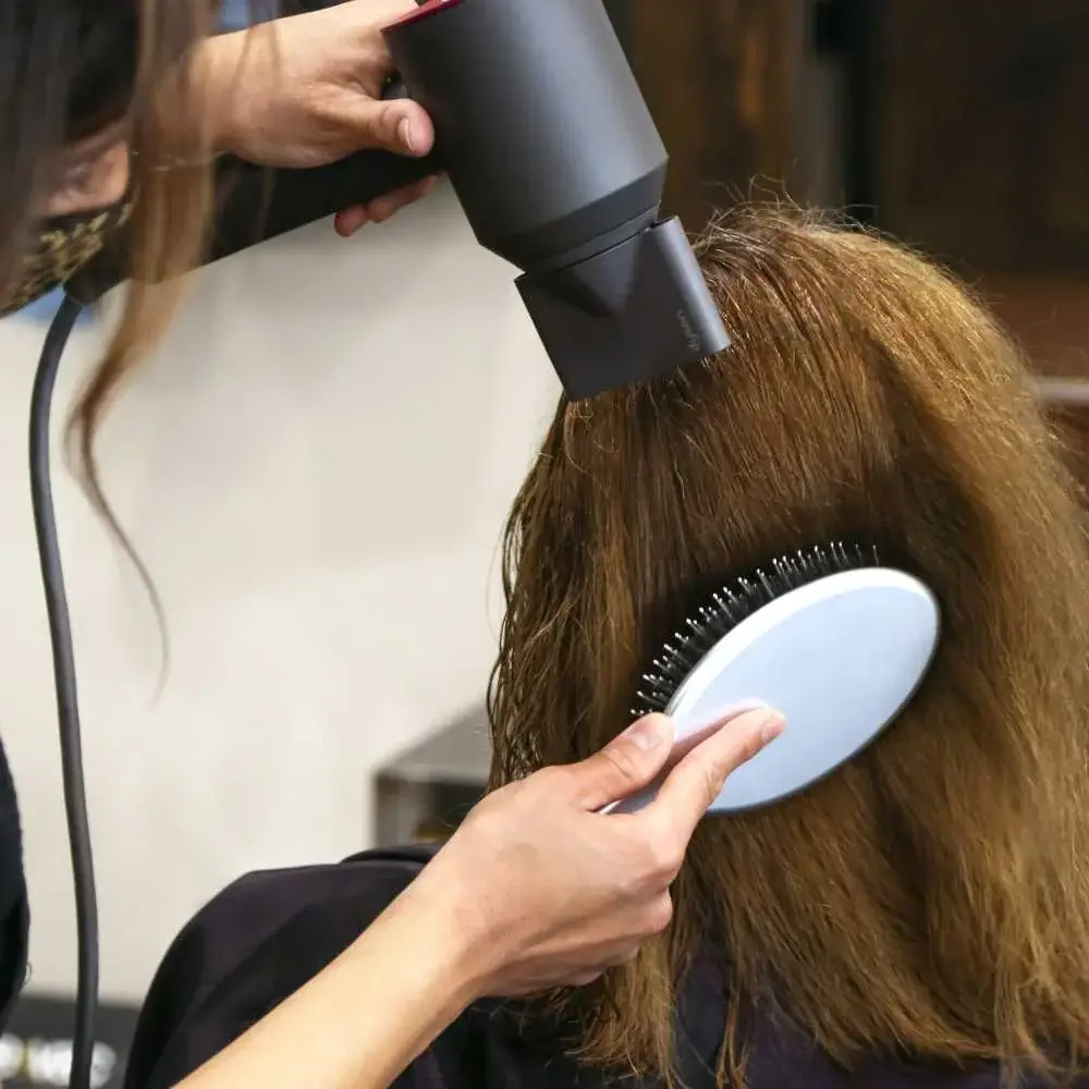 Brushing hair extensions with the market's best-rated brush