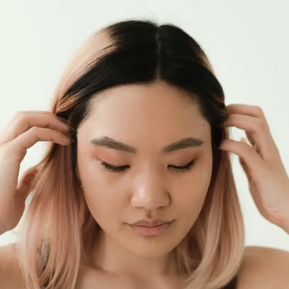 Woman achieving radiant skin using a top Korean concealer