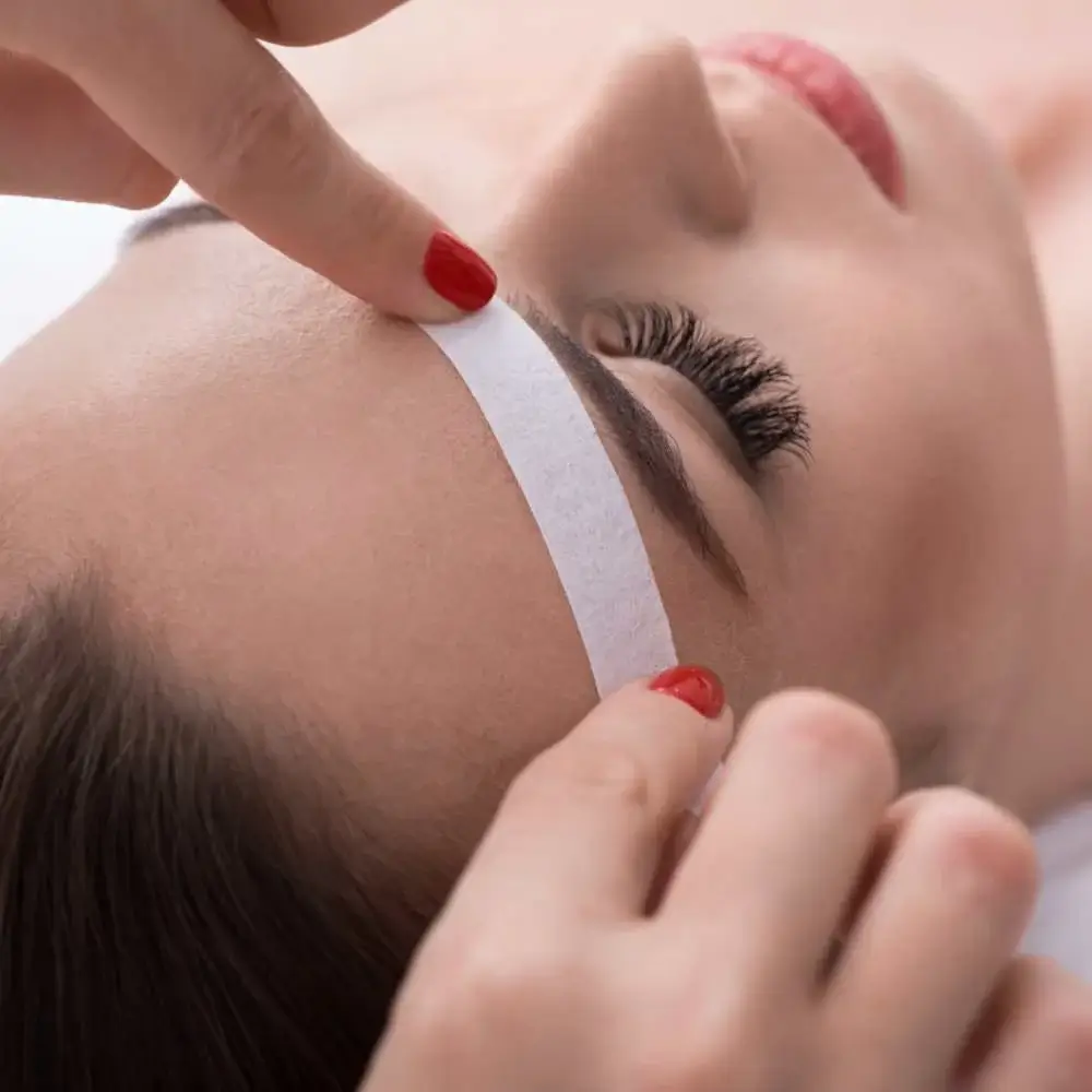 Woman revealing her perfectly waxed eyebrows using the top-rated wax