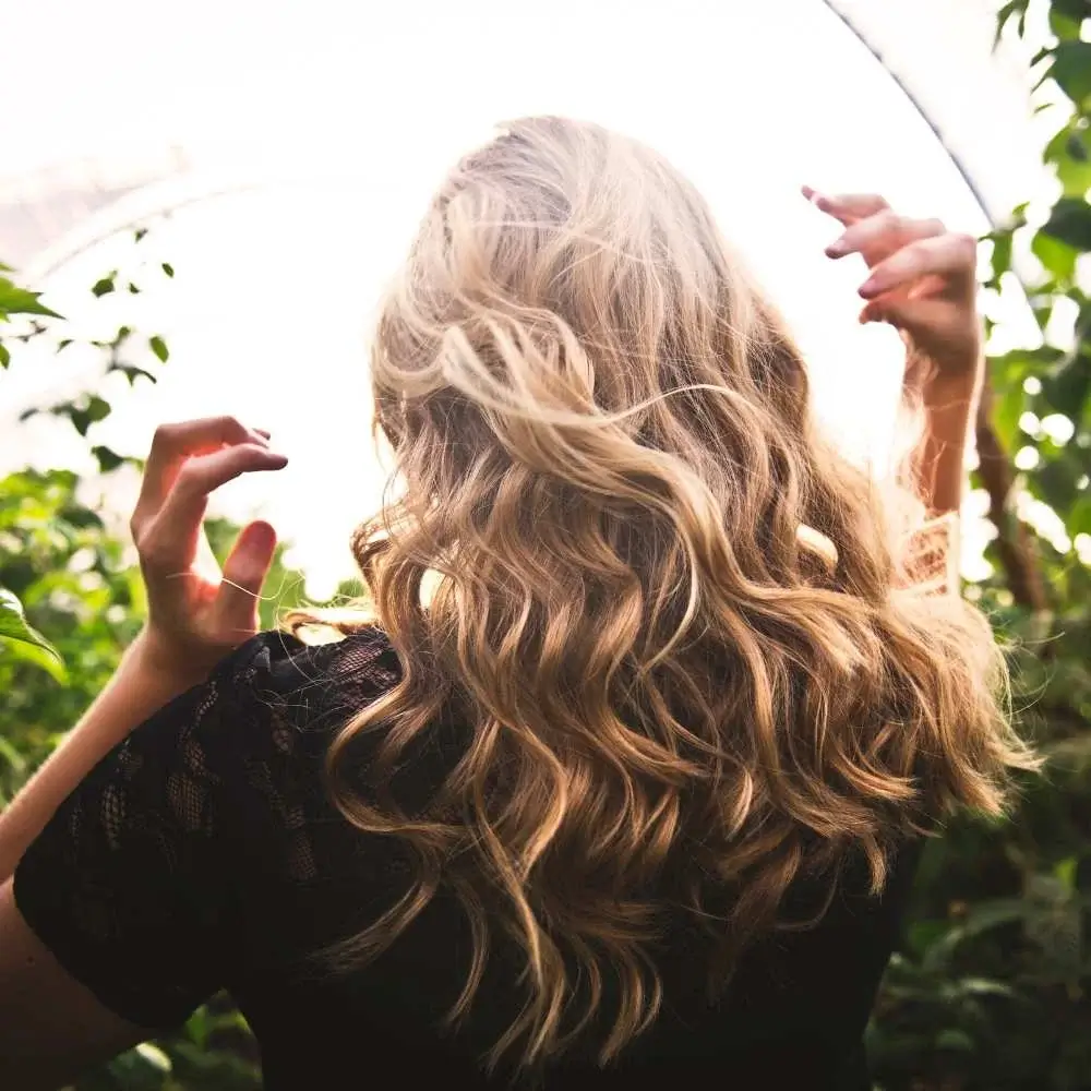 Woman flaunting curls achieved with best curling brush for fine hair