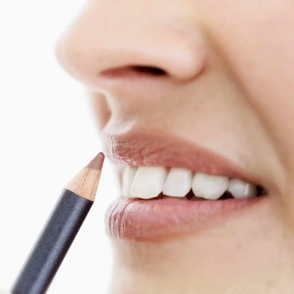 close-up of woman's lips and a lip liner