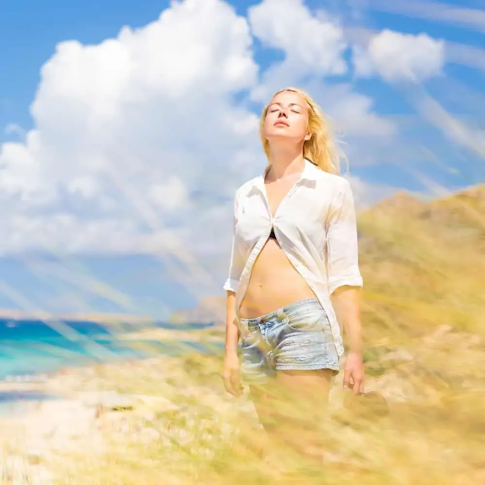 woman standing near the beach under the blue sky