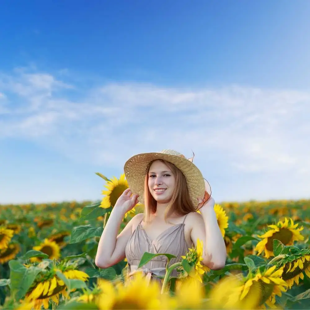 young woman in the middle of sunflower field