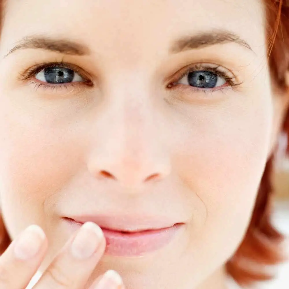 close-up shot of a woman touching her lips