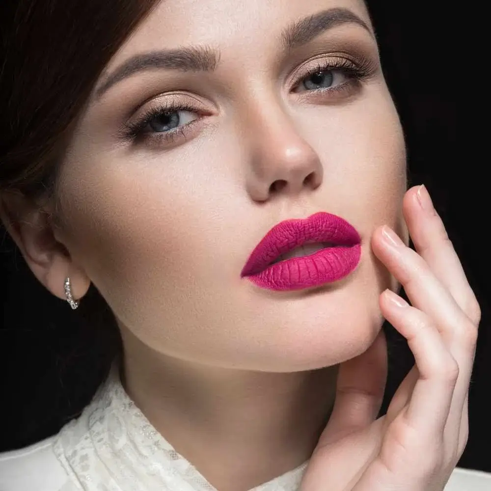 close-up shot of a beautiful woman with dark pink lips