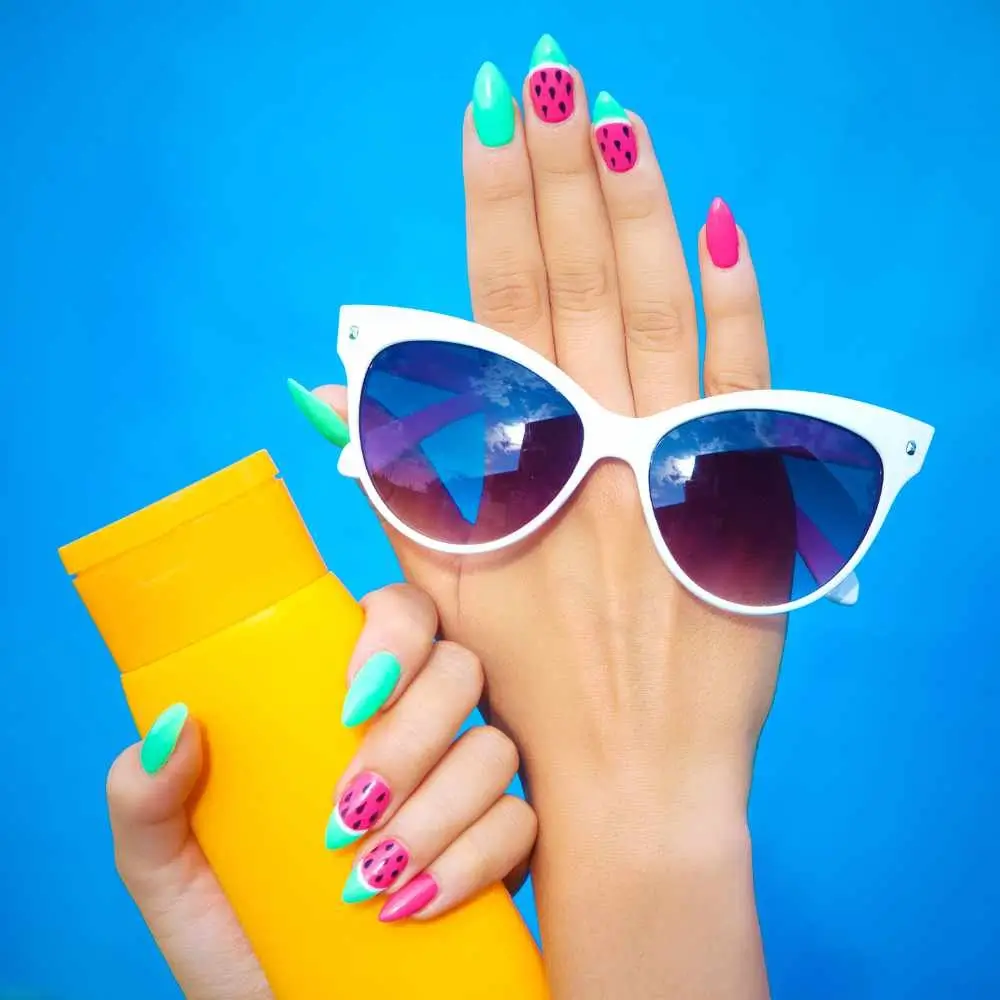 hands holding a sunscreen and sunglasses