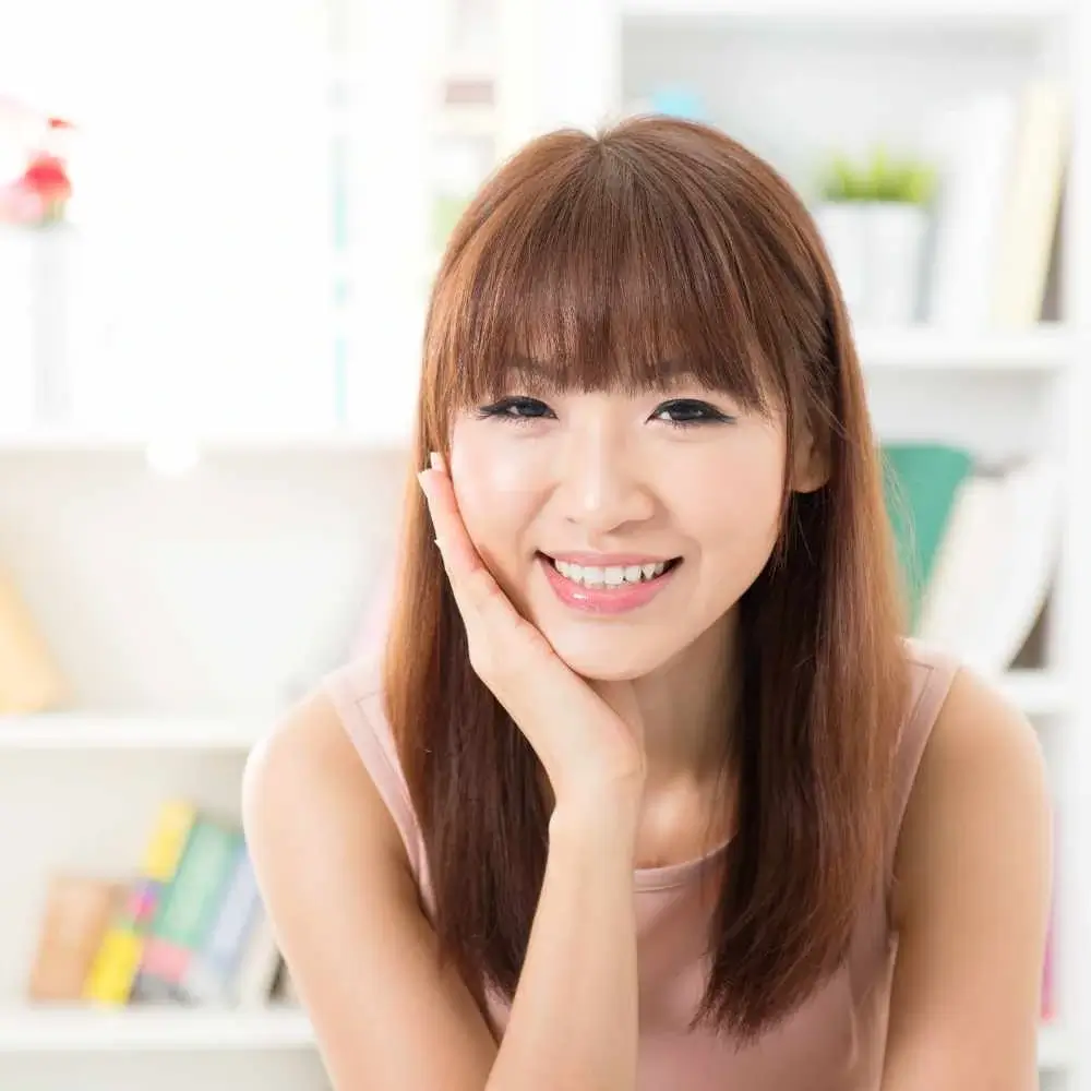 smiling asian woman with brown hair