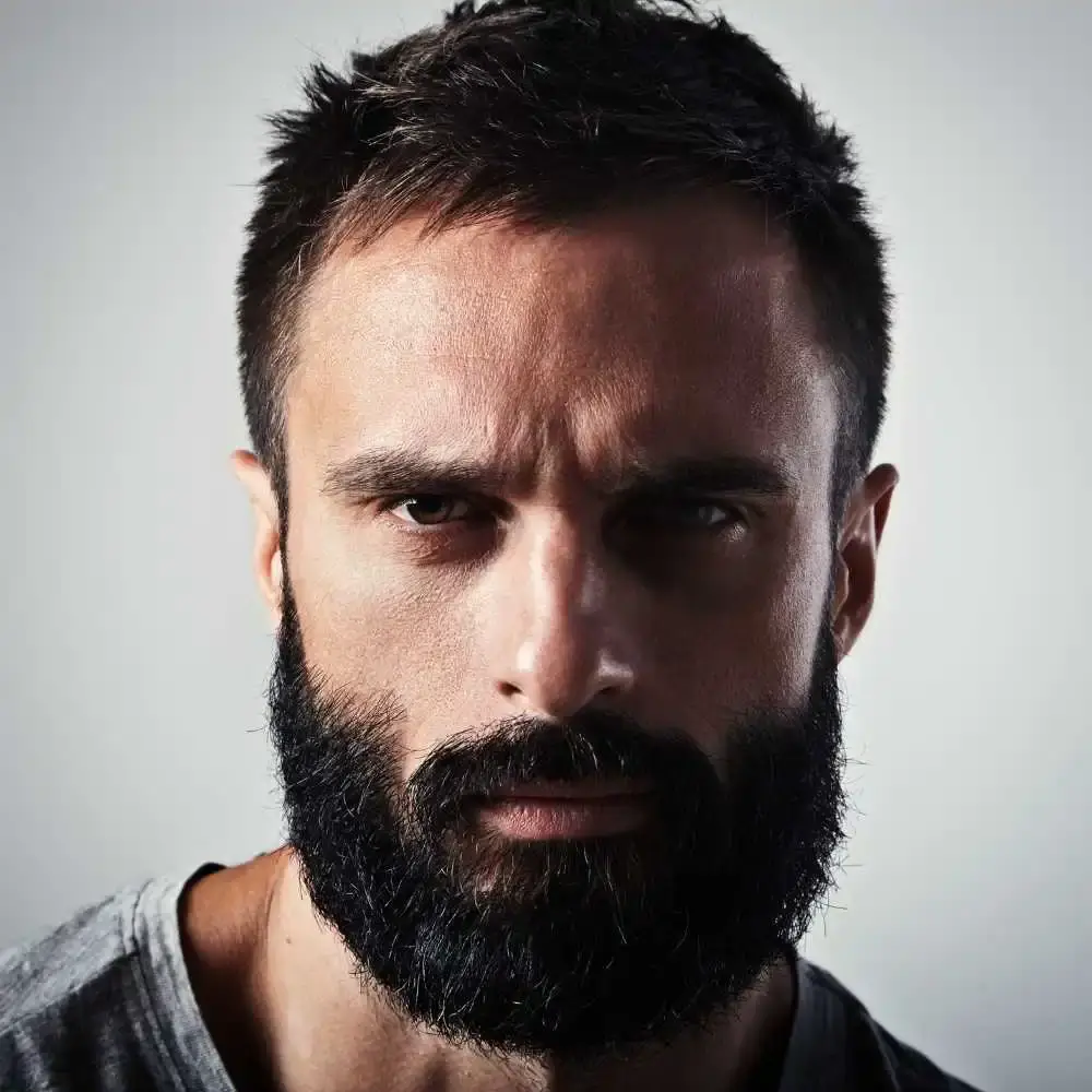 close-up portrait of a man with thick black beard