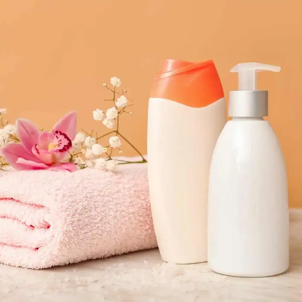 body wash and a towel topped with pink and flowers