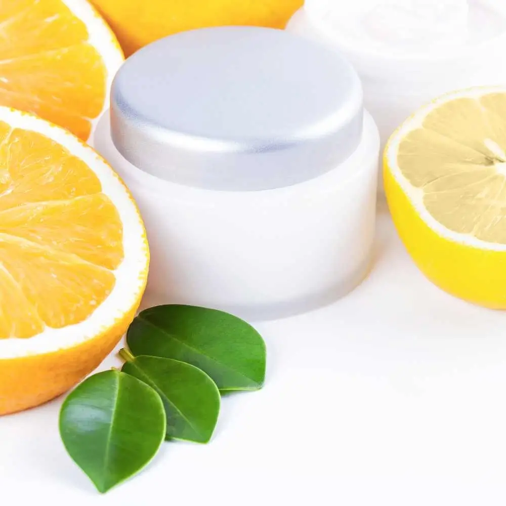 face cream surrounded by sliced lemons and leaves