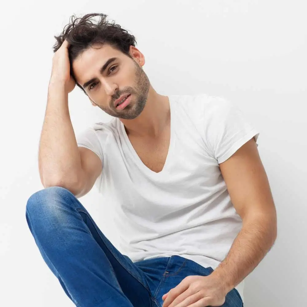 man wearing a white shirt and denim jeans