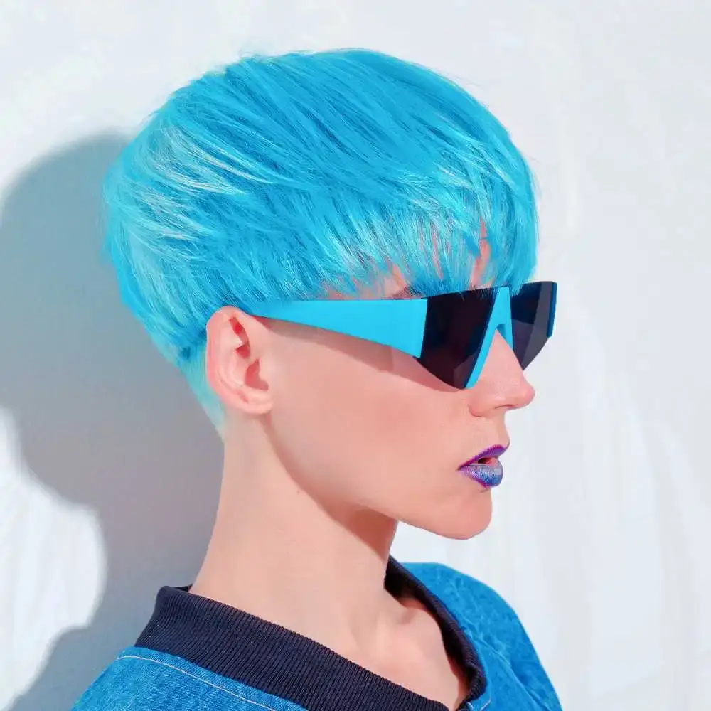 side view portrait of a woman with blue hair wearing blue stylish glasses