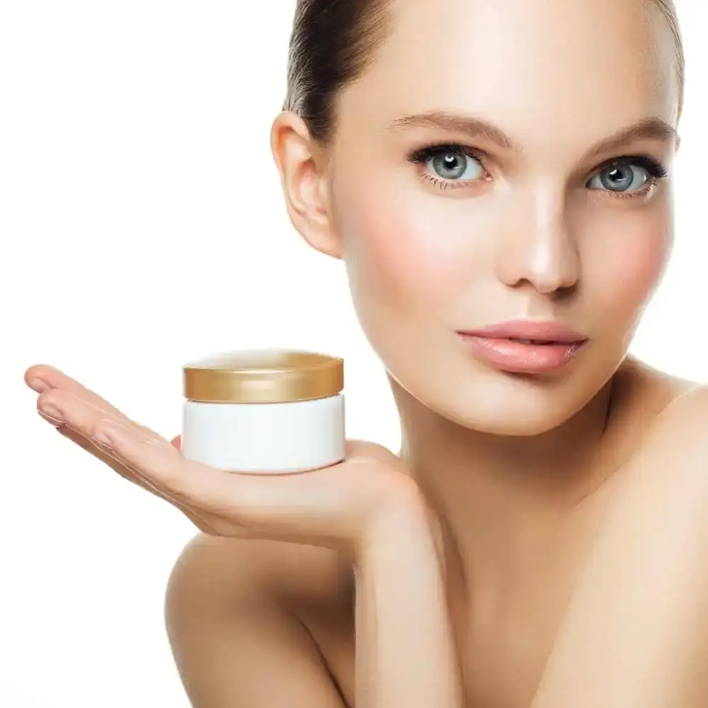 beautiful woman holding an eye cream