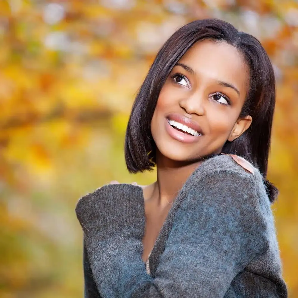 portrait of a woman with short hair and dark brown skin