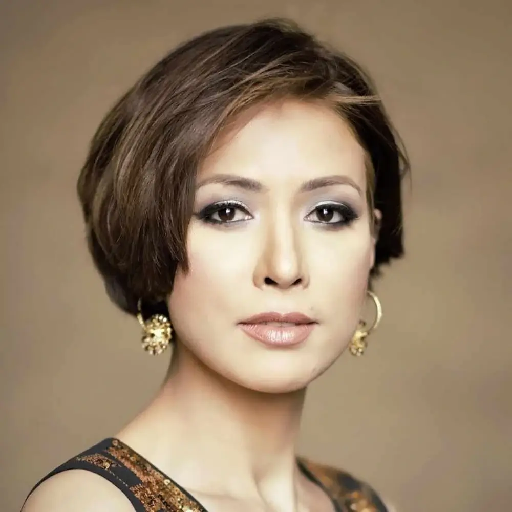 portrait of a woman with short brunette hair wearing earrings