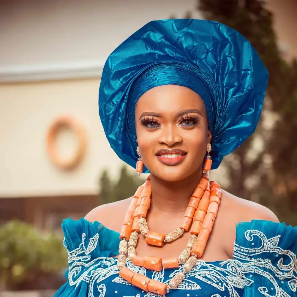 traditional african woman wearing a blue dress and blue head covering