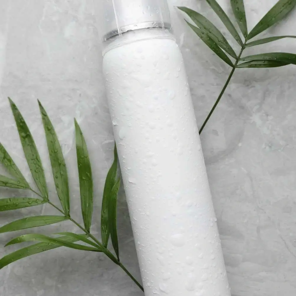 wet dry shampoo bottle with some leaves on the sides