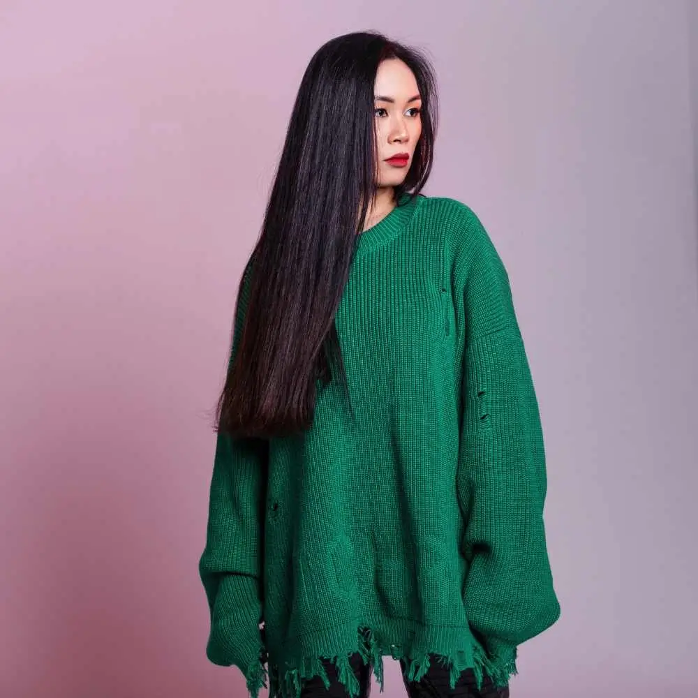 asian young woman with long black hair wearing stylish green sweater