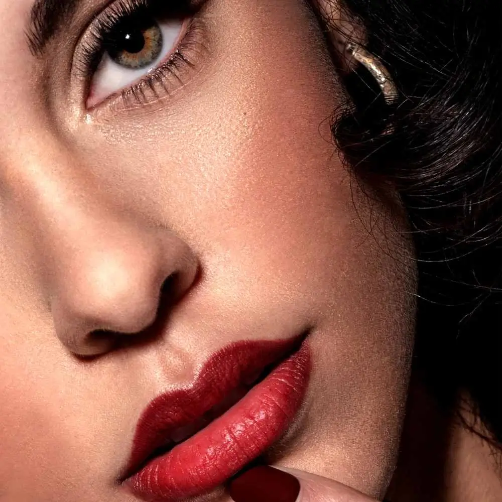 close-up photo of a woman's face wearing a dark red lipstick