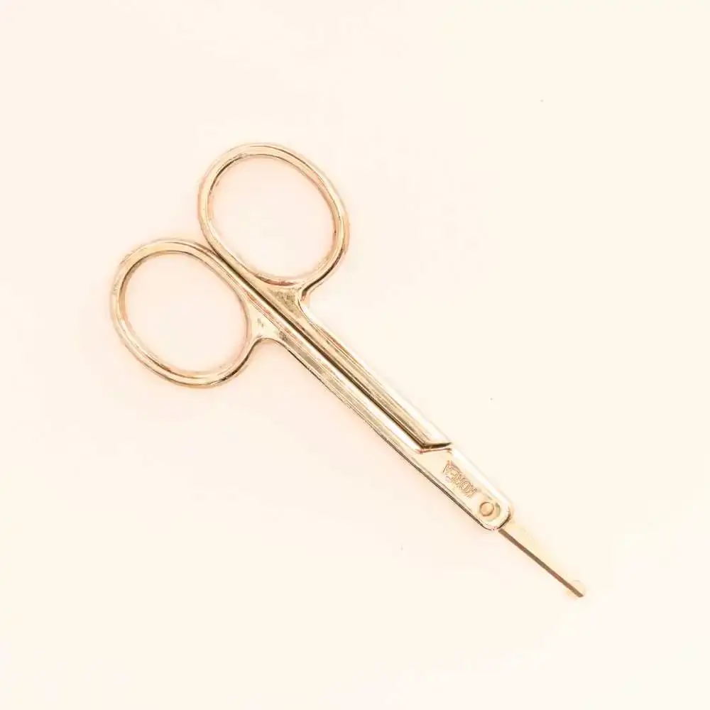 gold-colored eyebrow scissors