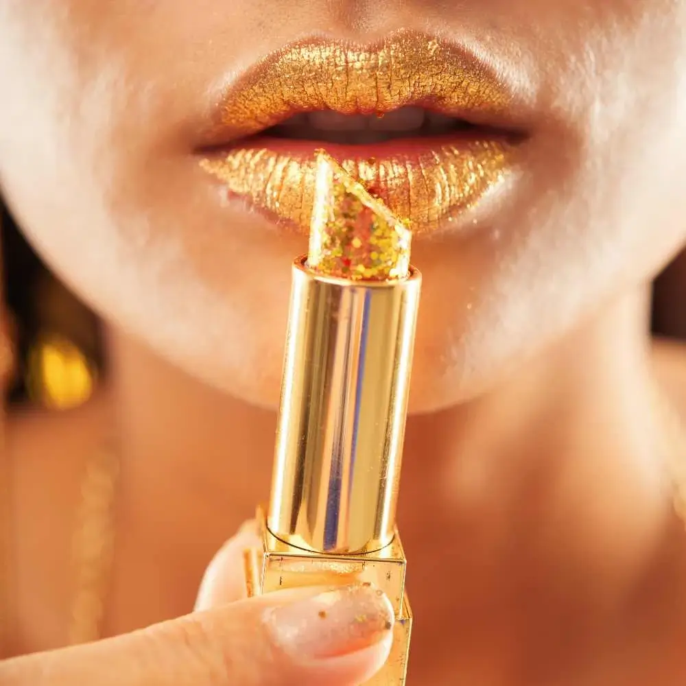 closeup of a woman's mouth in metallic gold lipstick