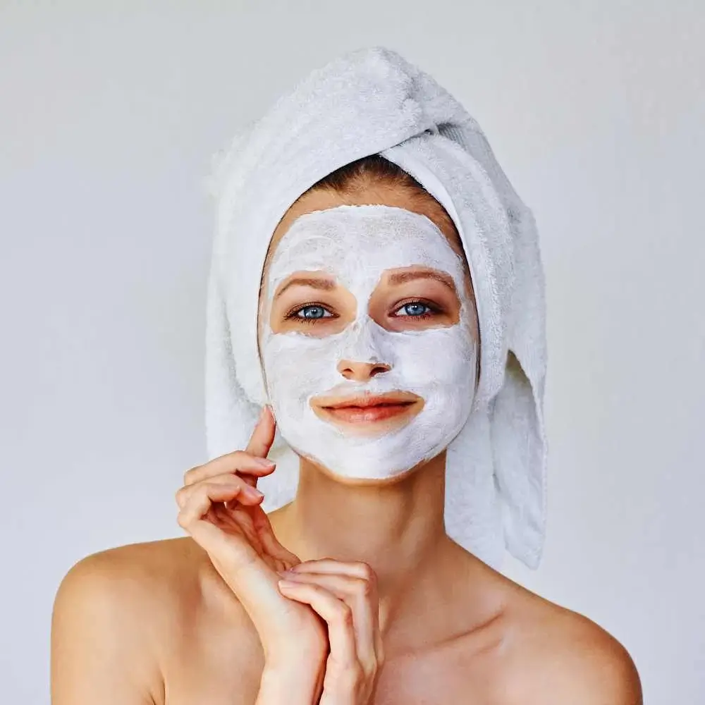 woman with a white clay mask on her face