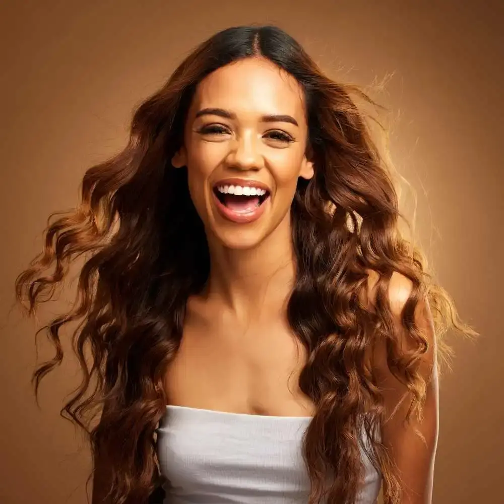 happy woman with her healthy and long curly hair