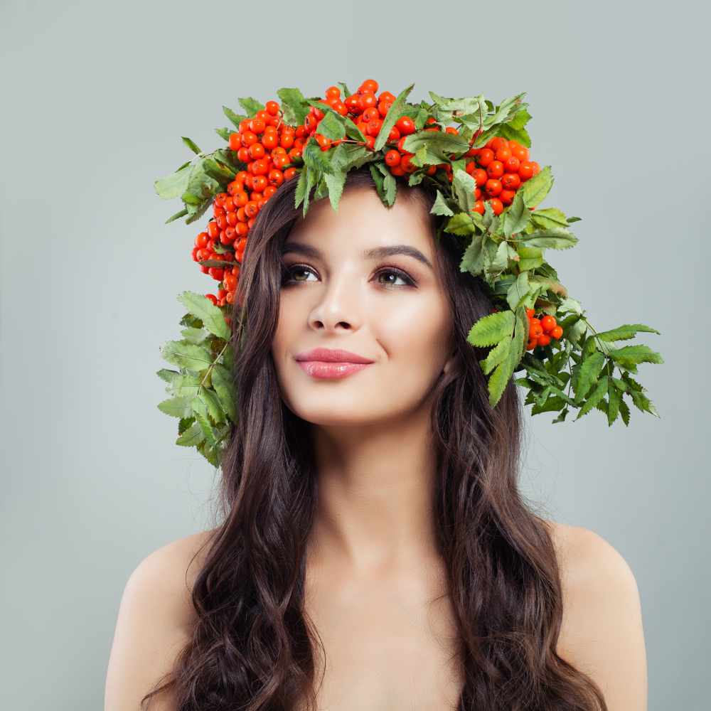 a woman with a natural makeup and wearing a headdress