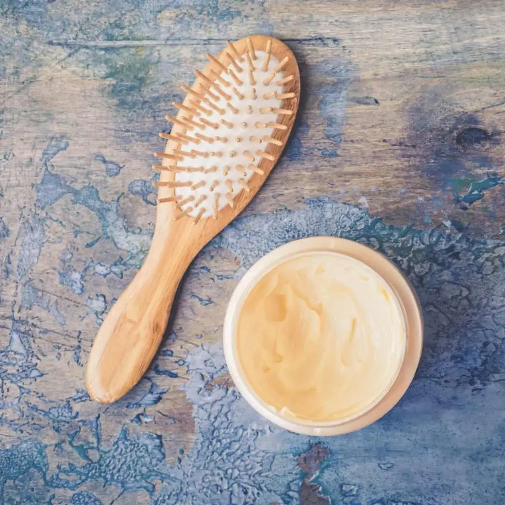 wooden hairbrush and a hair cream
