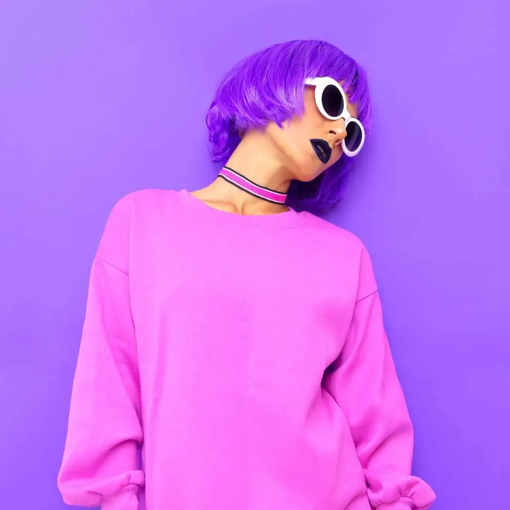 woman wearing a pink shirt and with short purple hair