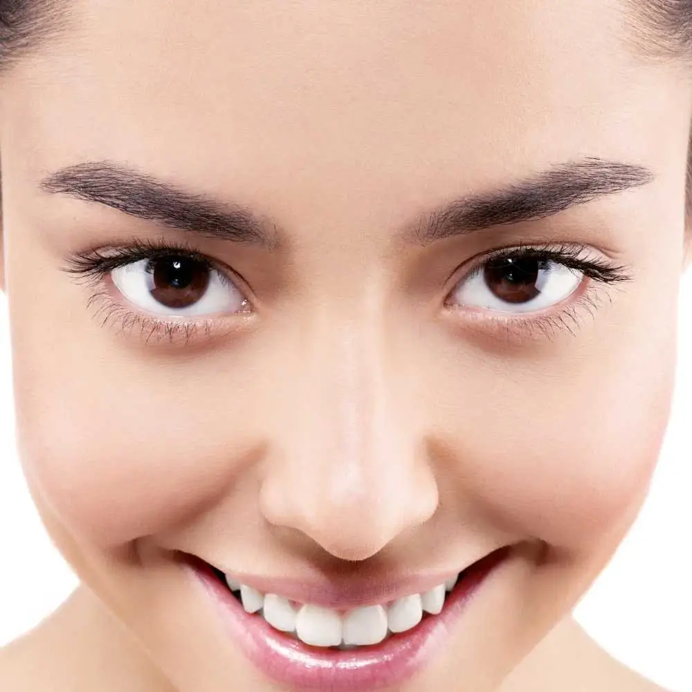 closeup portrait of a young woman with healthy clear skin and bright eyes 