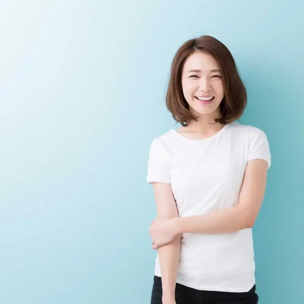 beautiful smiling Japanese woman with short hair wearing a white shirt