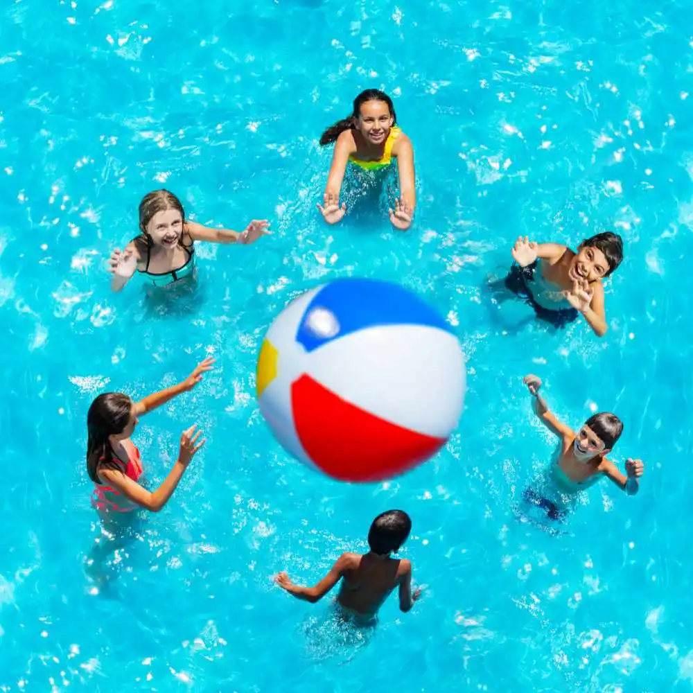 kids playing volleybal in the pool