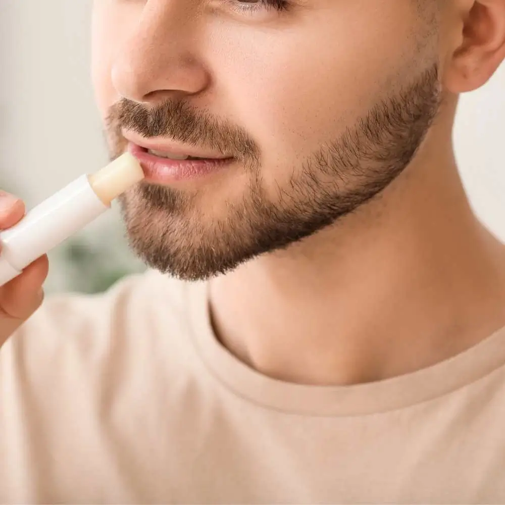 a man using lip balm