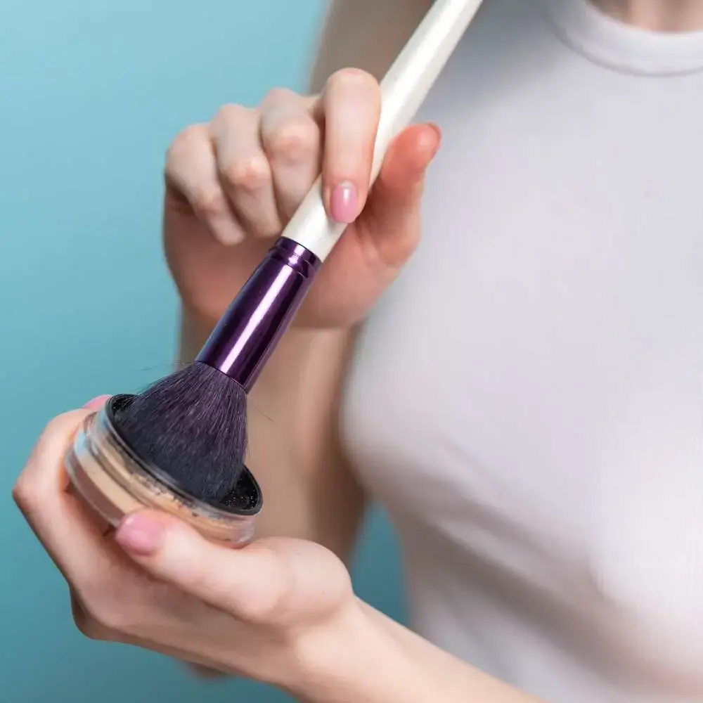 using purple makeup brush