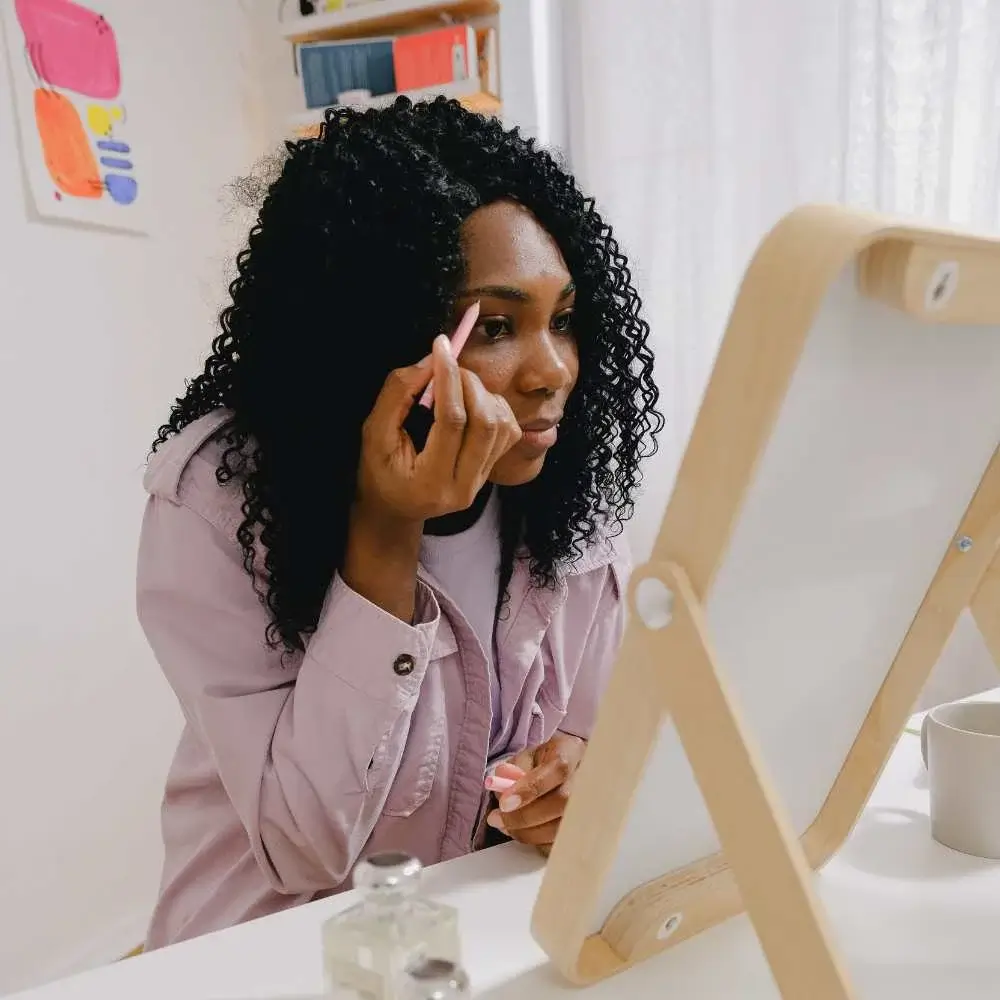 Woman skillfully applying the best drugstore eyebrow pencil