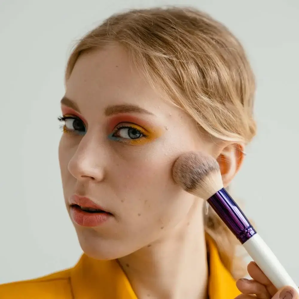 A model showcasing the perfect blush application on fair skin