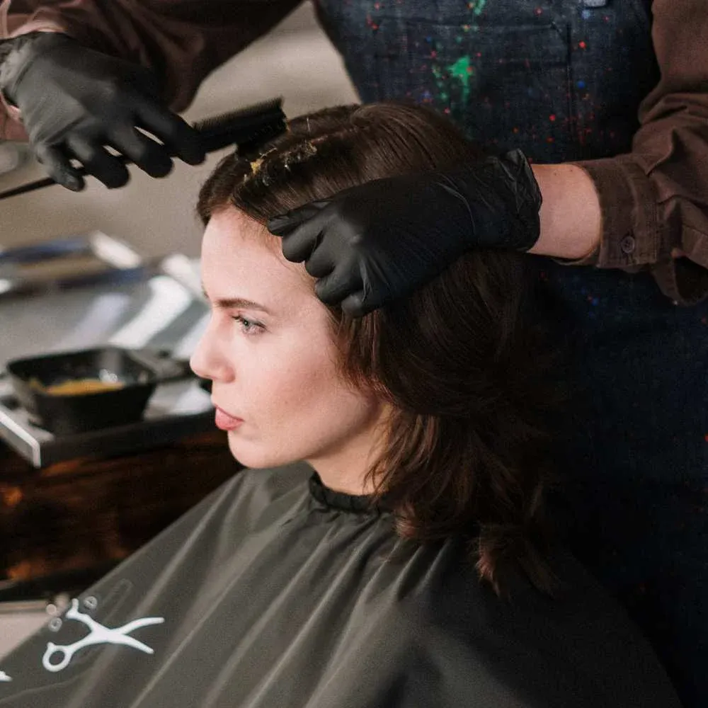 applying hair color at salon