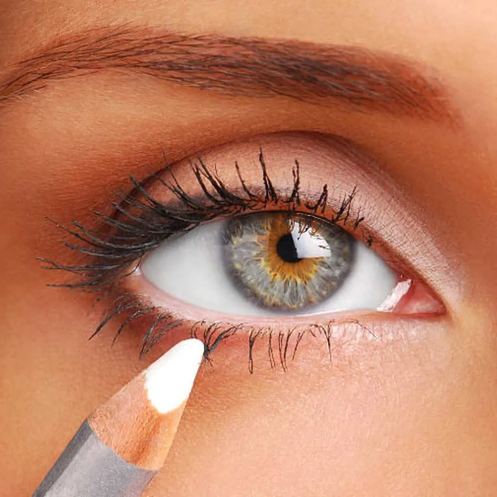 applying white eyeliner