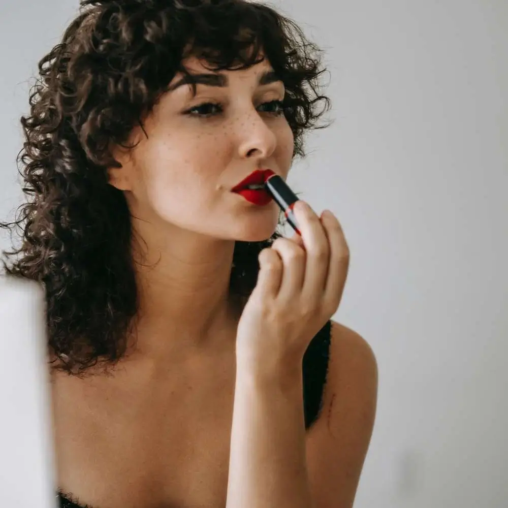 Applying red lipstick