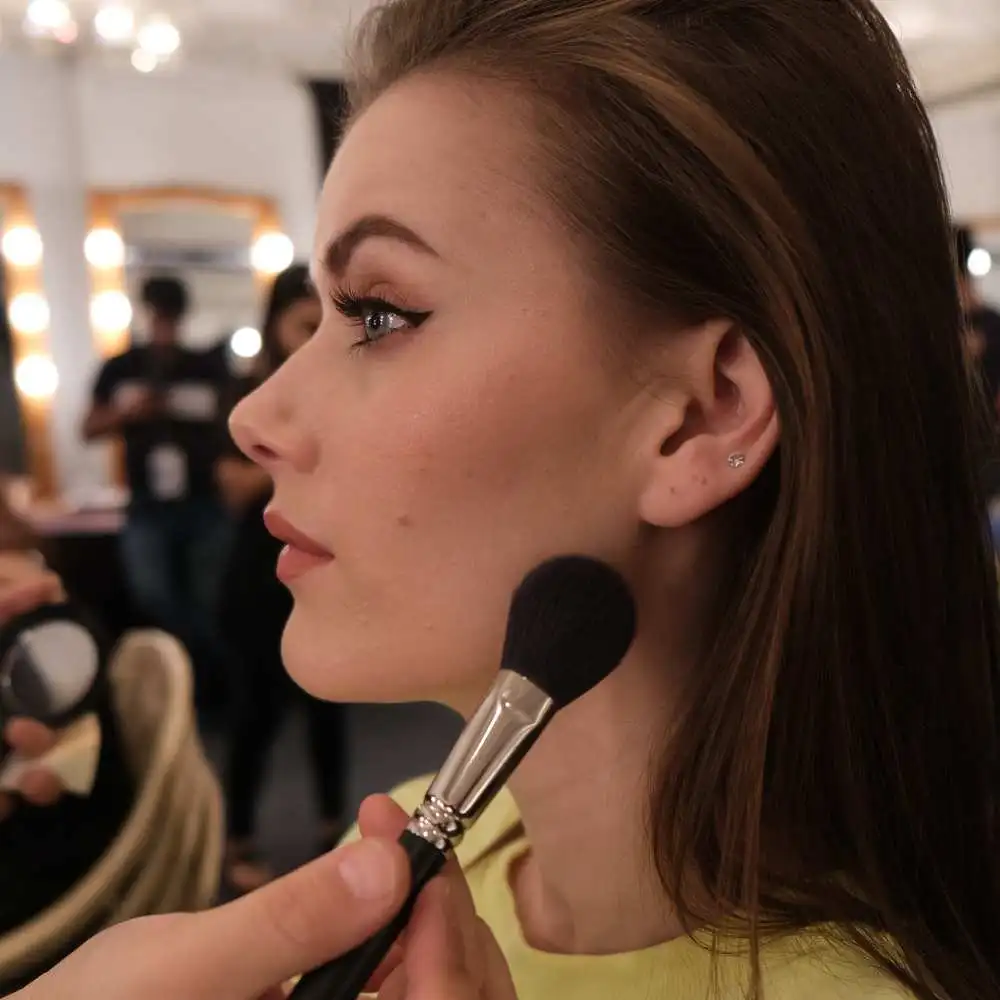 makeup artist putting foundation