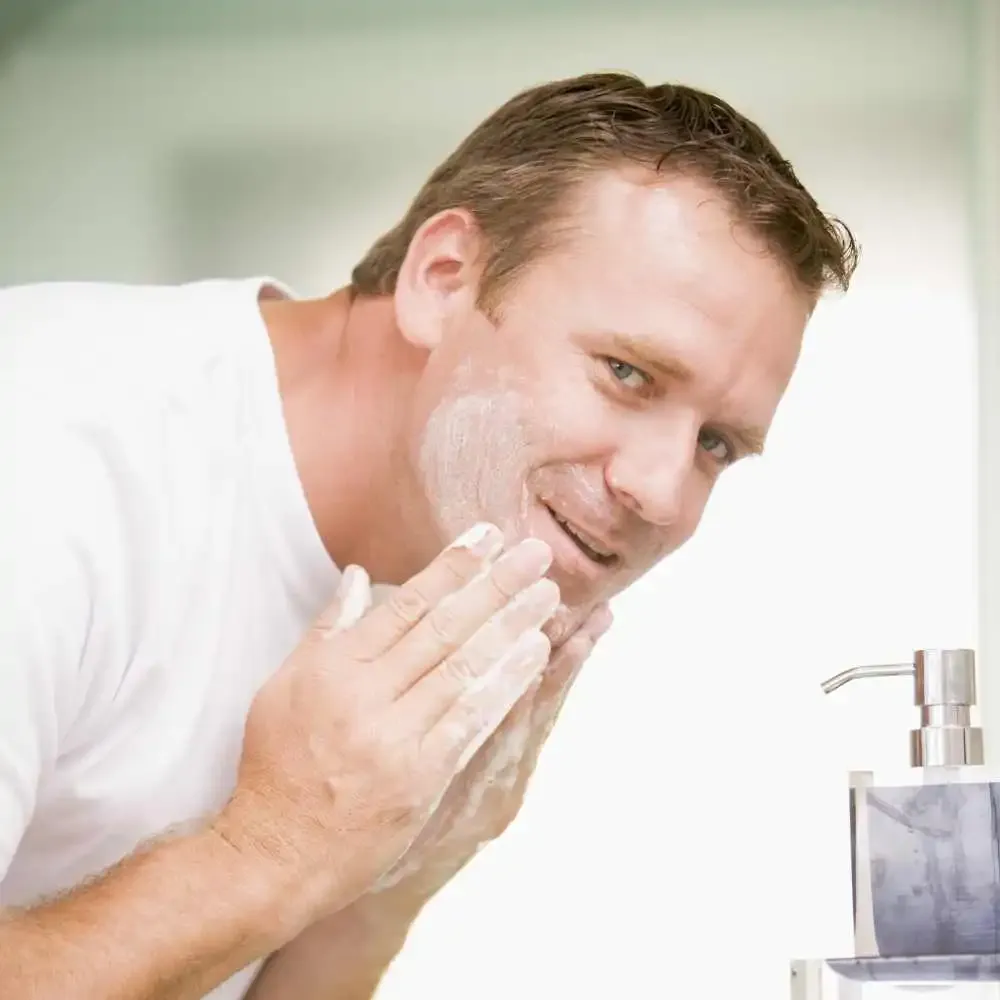 man washing his face