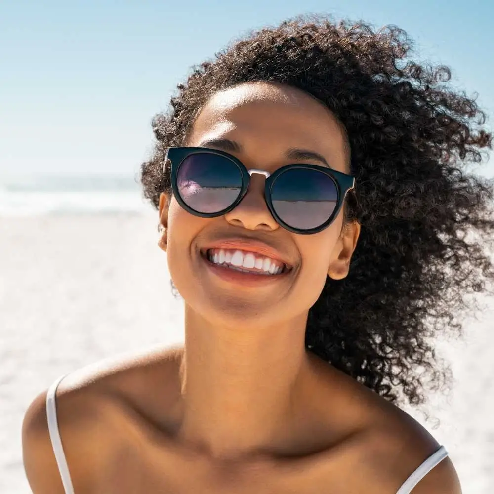 portrait of a beautiful smiling black woman on the beach
