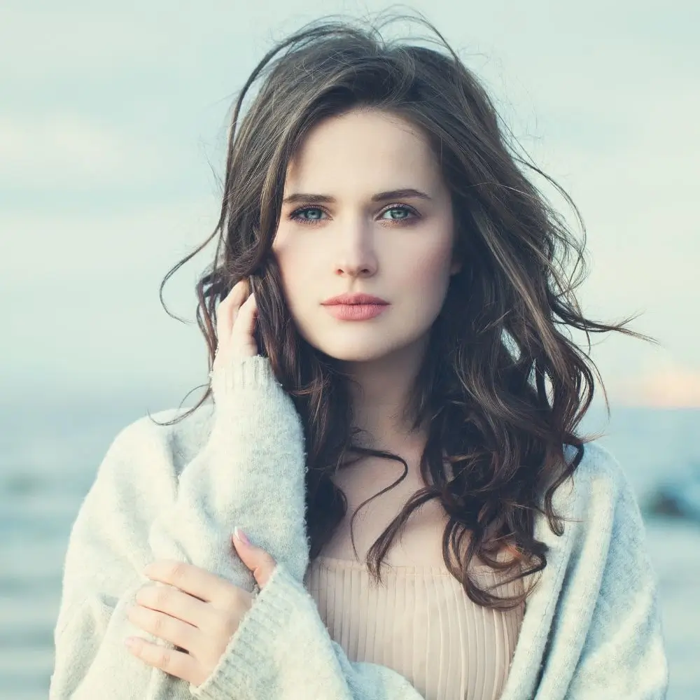 woman with curly hair wearing a sweater