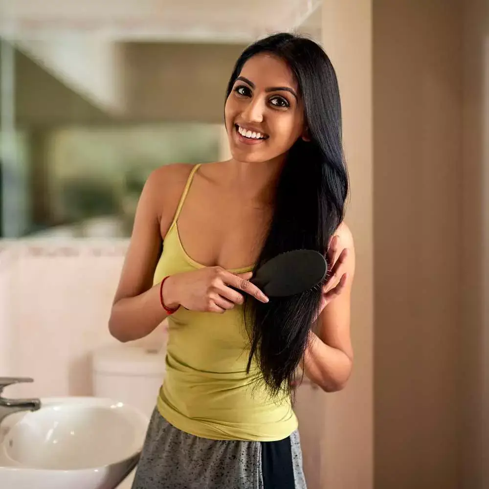 woman combing her black hair