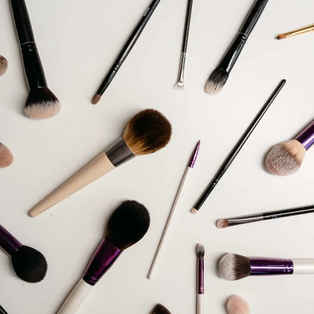 A variety of makeup brushes in the process of being cleaned