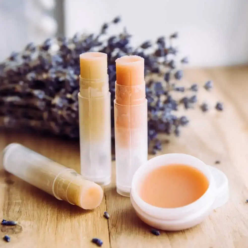A collection of men's lip balms with natural ingredients on a wooden table